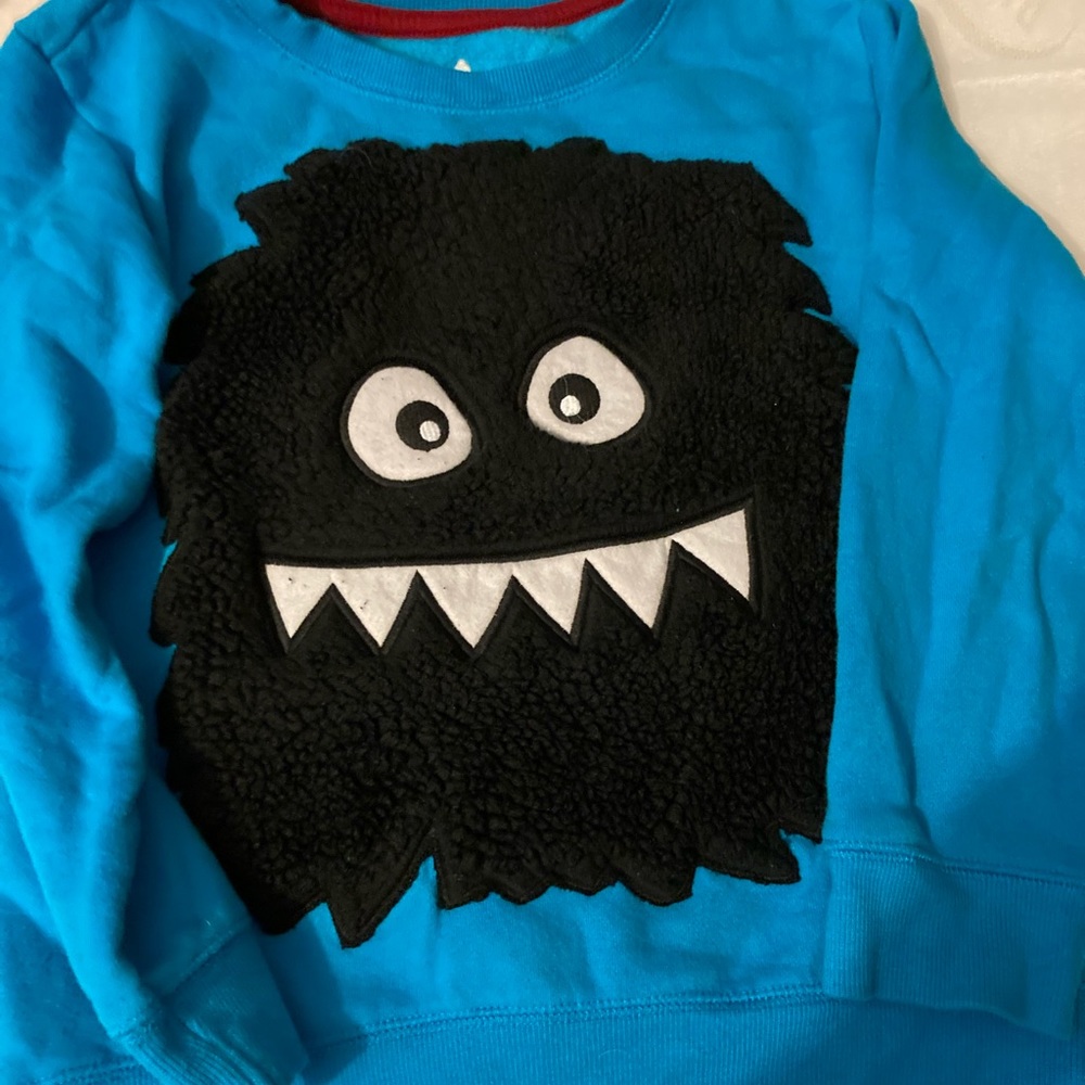 Beautiful blue heavy sweater with heavy textured monster